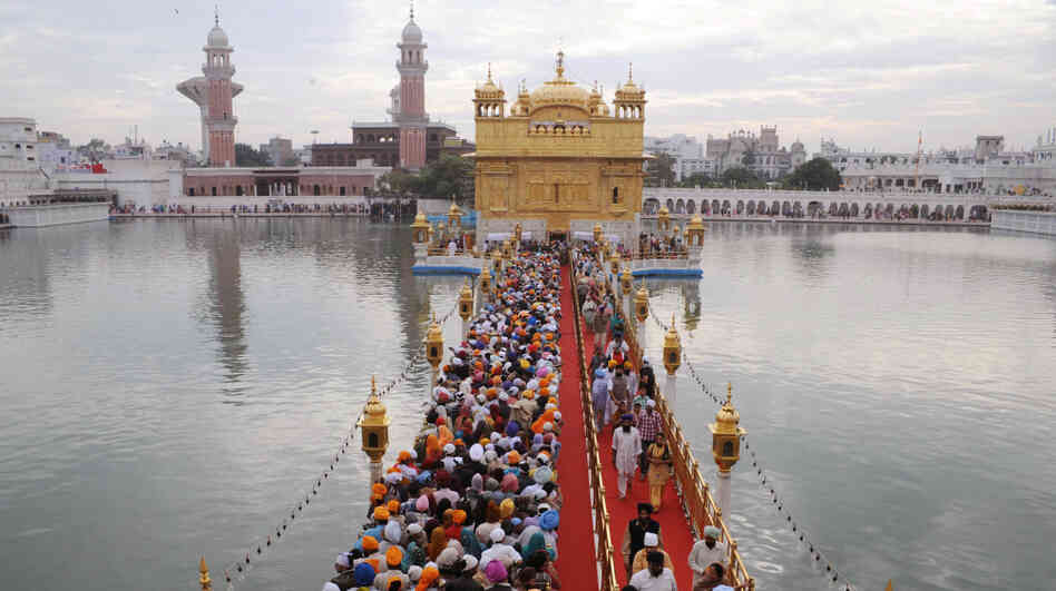 Sikh pilgrims stream into the Golden Temple in Amritsar, India, on Nov. 10. Devout Sikhs from all over India and the world come to Amritsar by the tens of thousands every day â adding to an already sizable carbon footprint. So city and temple officials have joined an environmental group to learn how to incorporate environmentally friendly practices. Sikh pilgrims stream into the Golden Temple in Amritsar, India, on Nov. 10. Devout Sikhs from all over India and the world come to Amritsar by the tens of thousands every day â adding to an already sizable carbon footprint. So city and temple officials have joined an environmental group to learn how to incorporate environmentally friendly practices.