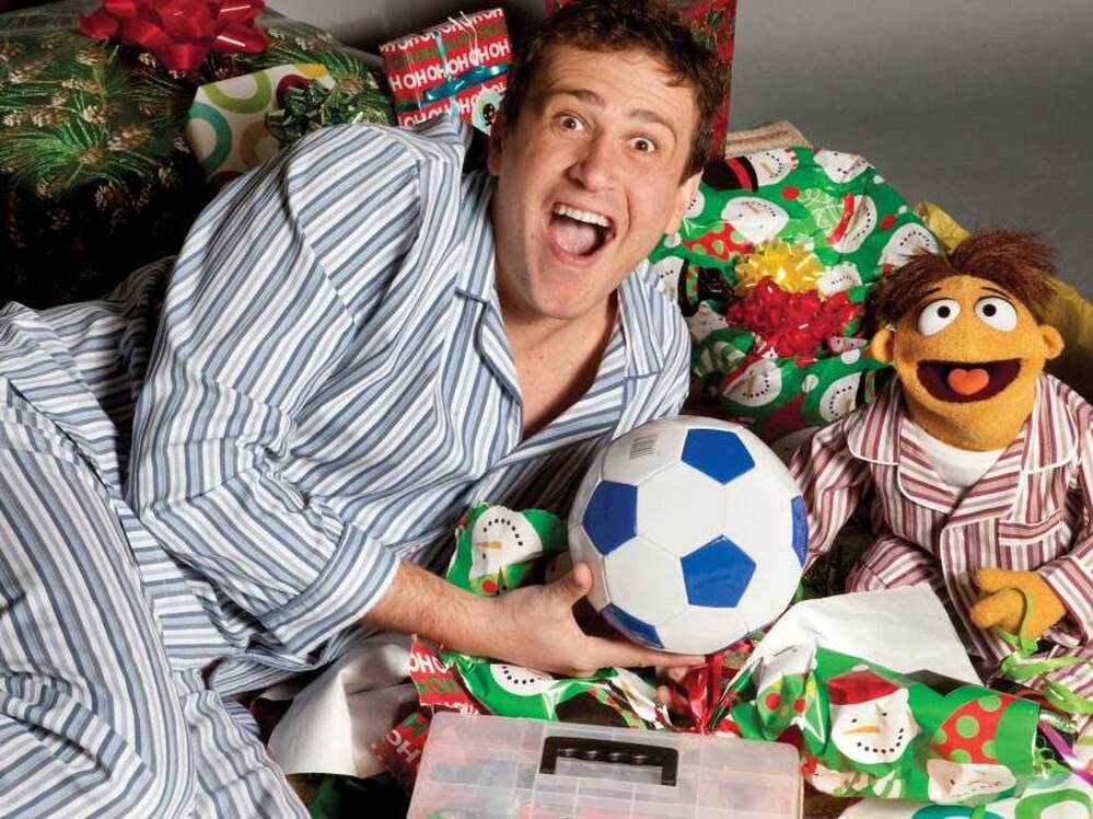 Jason Segel (left) and Walter (voiced by Peter Linz) try to reunite the original Muppets in the new family comedy The Muppets. 