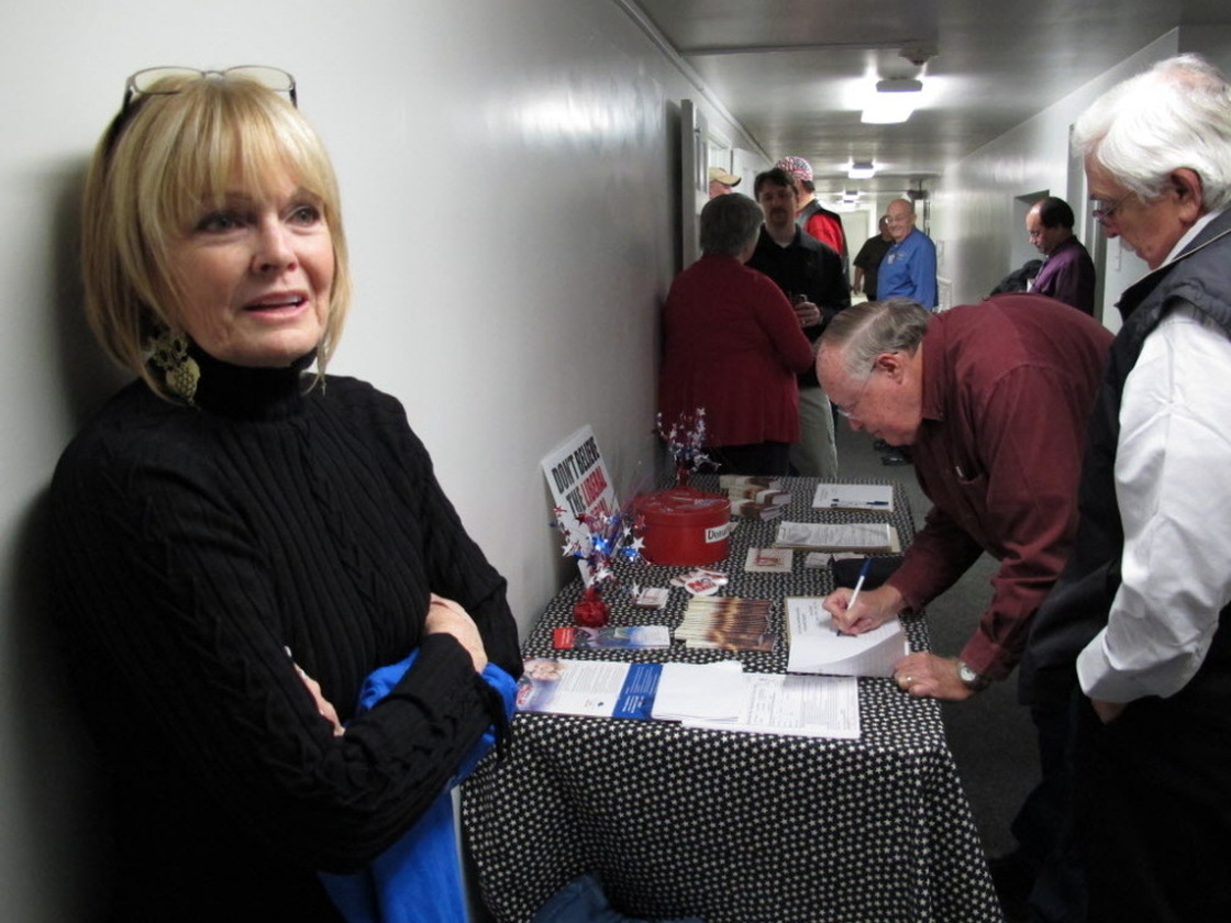 Mid-South Tea Party member Jan Allen stands by front of the sign-in desk before Thursday's meeting near Memphis. 