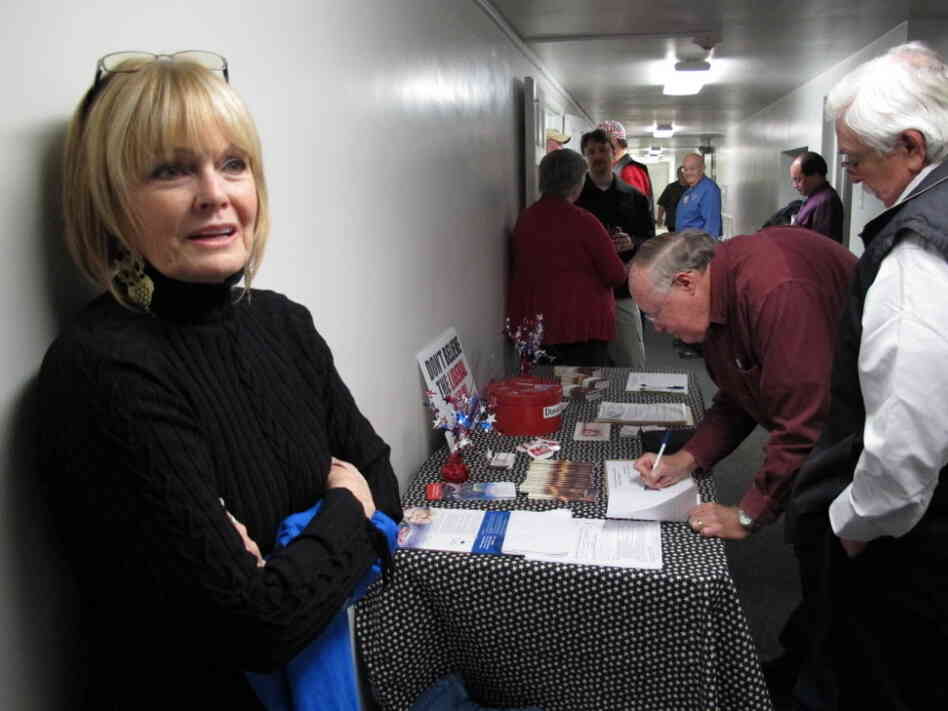 Mid-South Tea Party member Jan Allen stands by front of the sign-in desk before Thursday's meeting near Memphis. 