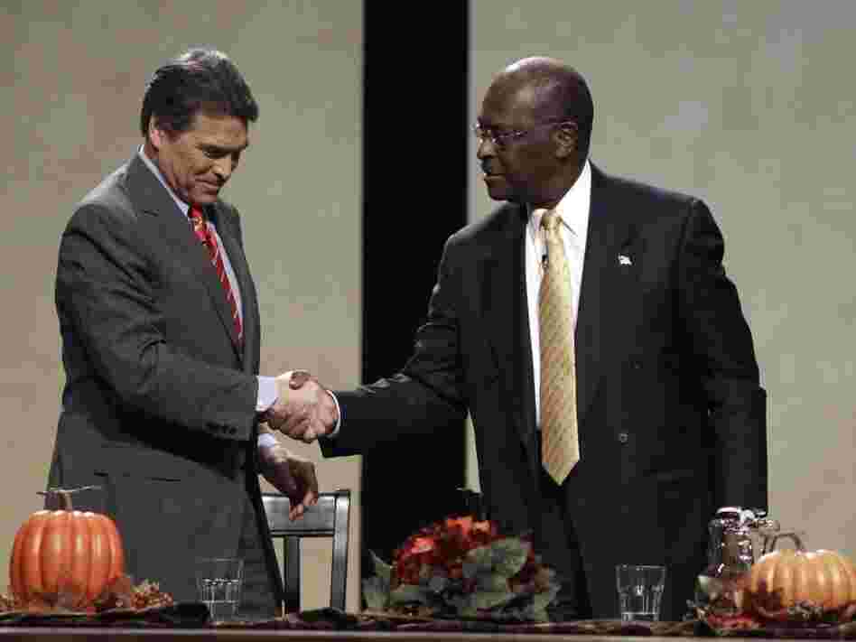 Republican presidential candidates Texas Gov. Rick Perry and former CEO of Godfather's Pizza Herman Cain talk after a forum sponsored by The Family Leader Saturday. Both men let their emotions show during the roundtable.