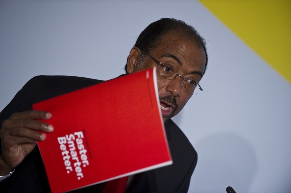 Executive Director of UNAIDS Michel Sidibé holds up a copy of the UNAIDS World AIDS Day Report 2011 as he addresses a press conference.