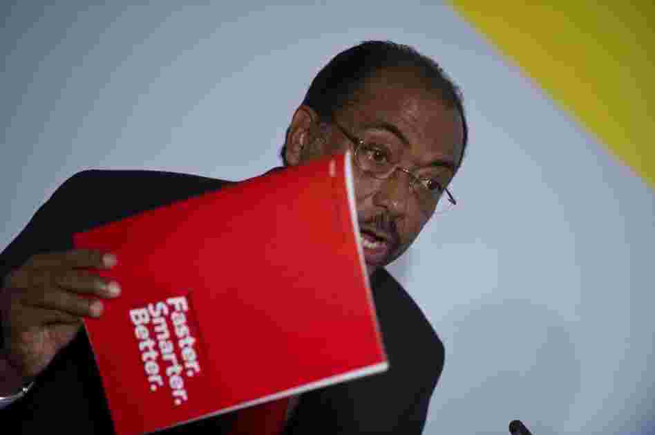 Executive Director of UNAIDS Michel Sidibé holds up a copy of the UNAIDS World AIDS Day Report 2011 as he addresses a press conference.