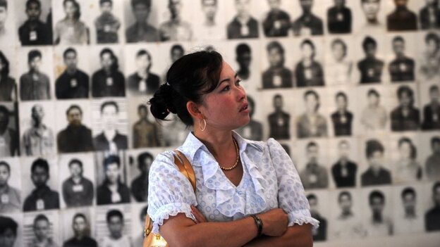 A Cambodian woman looks at portraits of Khmer Rouge victims at the Tuol Sleng genocide museum in the capital Phnom Penh on Nov. 17. Three senior Khmer Rouge leaders are on trial in what may be the last major legal case against the group's leaders.