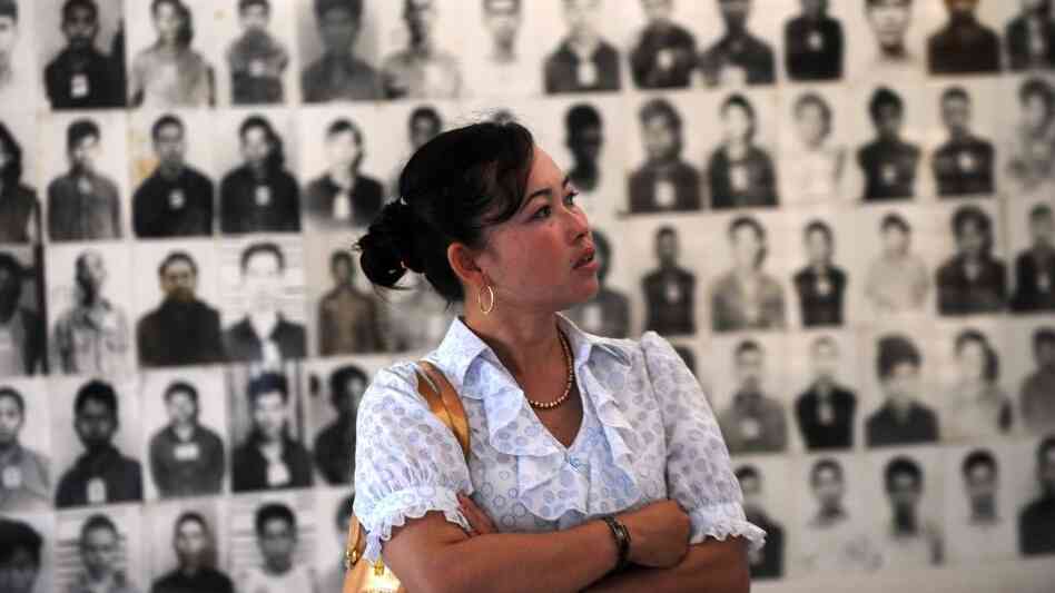 A Cambodian woman looks at portraits of Khmer Rouge victims at the Tuol Sleng genocide museum in the capital Phnom Penh on Nov. 17. Three senior Khmer Rouge leaders are on trial in what may be the last major legal case against the group's leaders.