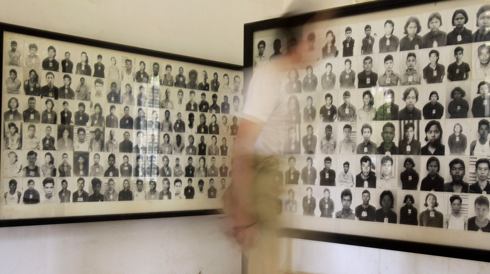 A tourist views photos of former Khmer Rouge prisoners at the Tuol Sleng genocide museum, formerly the regime's notorious S-21 prison, in Phnom Penh, Cambodia, in a photo from 2009. 