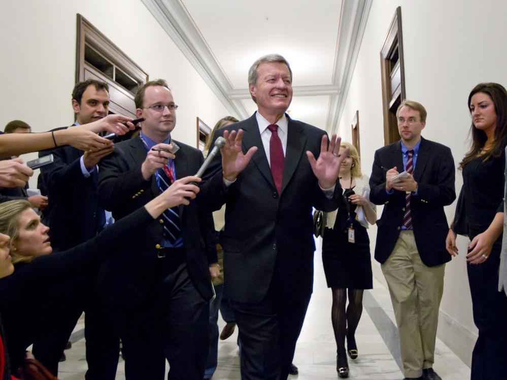 Senate Finance Committee Chairman Sen. Max Baucus, D-Mont., a member of the congressional supercommittee on the deficit, fends off reporters as he arrives to meet in the Capitol Hill office of Sen. John Kerry, D-Mass., on Monday.