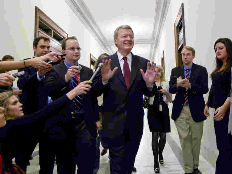 Senate Finance Committee Chairman Sen. Max Baucus, D-Mont., a member of the congressional supercommittee on the deficit, fends off reporters as he arrives to meet in the Capitol Hill office of Sen. John Kerry, D-Mass., on Monday.