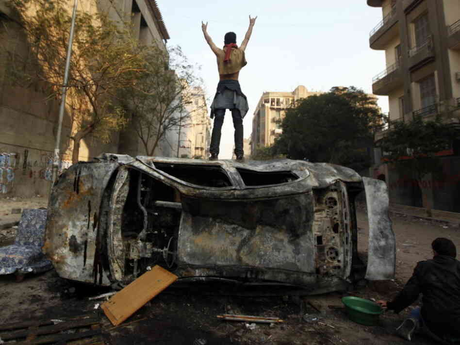 Earlier today a protester stood on top of a burned car in Tahrir Square in Cairo, Egypt.