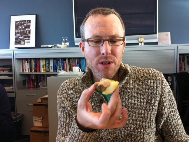 Mike contemplates the cupcake. 