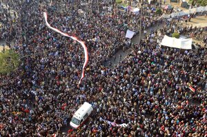 Thousands of people attend a rally in Tahrir Square to demand that the ruling military council cede power to a civilian government.