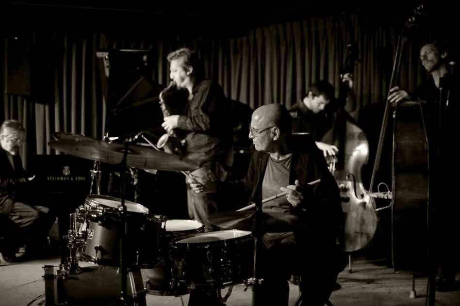 Paul Motian with his Trio 2000 + 2, at the Village Vanguard. L-R: Masabumi Kikuchi, Loren Stillman, Motian, Thomas Morgan, Ben Street. Paul Motian with his Trio 2000 + 2, at the Village Vanguard. L-R: Masabumi Kikuchi, Loren Stillman, Motian, Thomas Morgan, Ben Street.