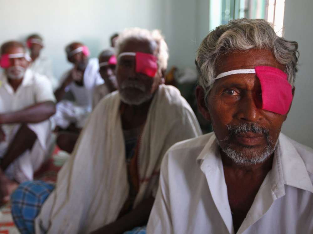 Patients sit after their cataract surgeries at a hospital of the Aravind Eye Care System in Madurai, India.