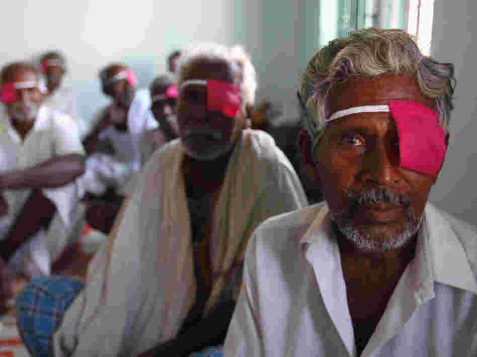 Patients sit after their cataract surgeries at a hospital of the Aravind Eye Care System in Madurai, India.