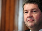 U.S. Postmaster General Patrick Donahoe said Monday that the Postal Service is in "a deep financial crisis" because it has a "business model that is tied to the past." U.S. Postmaster General Patrick Donahoe said Monday that the Postal Service is in "a deep financial crisis" because it has a "business model that is tied to the past."