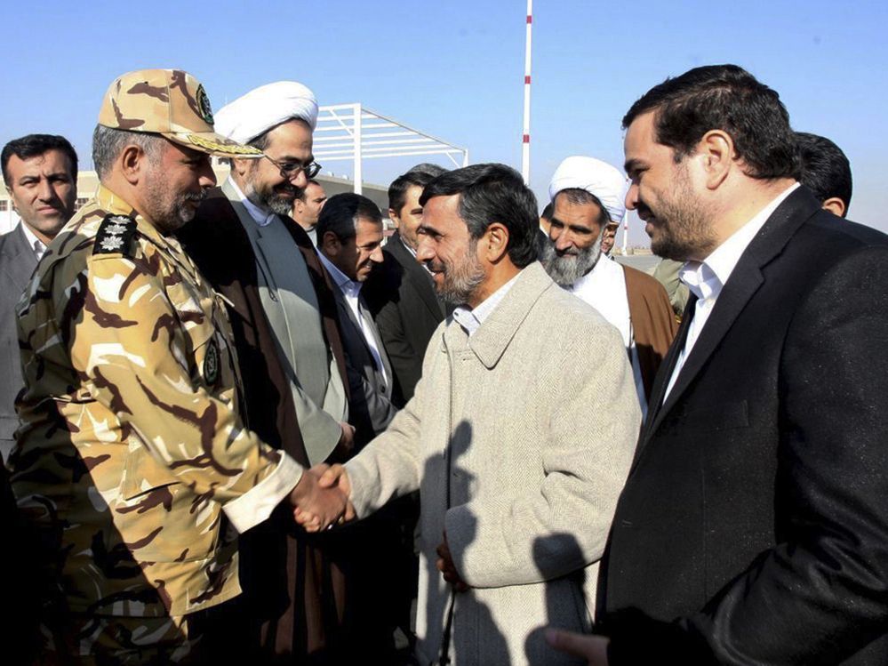 Iranian President Mahmoud Ahmadinejad shakes hands with an unidentified army colonel in Shahr-e-Kord, Iran, Nov. 9, 2011. 