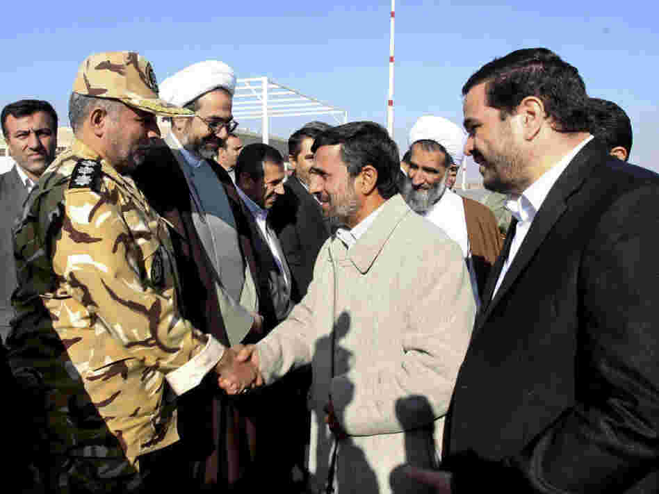 Iranian President Mahmoud Ahmadinejad shakes hands with an unidentified army colonel in Shahr-e-Kord, Iran, Nov. 9, 2011. 