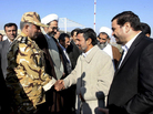 Iranian President Mahmoud Ahmadinejad shakes hands with an unidentified army colonel in Shahr-e-Kord, Iran, Nov. 9, 2011. Iranian President Mahmoud Ahmadinejad shakes hands with an unidentified army colonel in Shahr-e-Kord, Iran, Nov. 9, 2011.