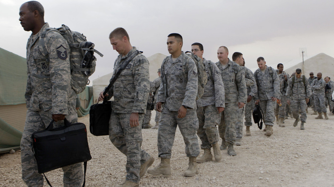 U.S. servicemen line up to board a bus as they begin their journey home at Al Asad Air Base west of Baghdad, Iraq, on Nov. 1. The U.S. has promised to withdraw from Iraq by the end of the year as required by a 2008 security agreement between Washington and Baghdad. Some 39,000 U.S. troops are scheduled to clear out along with their equipment. 