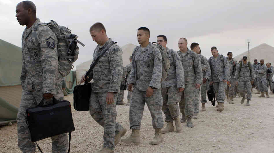 U.S. servicemen line up to board a bus as they begin their journey home at Al Asad Air Base west of Baghdad, Iraq, on Nov. 1. The U.S. has promised to withdraw from Iraq by the end of the year as required by a 2008 security agreement between Washington and Baghdad. Some 39,000 U.S. troops are scheduled to clear out along with their equipment. 
