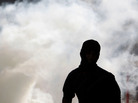 Anti-government protester runs away from tear gas fired by riot police Wednesday in A'ali, Bahrain. Anti-government protester runs away from tear gas fired by riot police Wednesday in A'ali, Bahrain.
