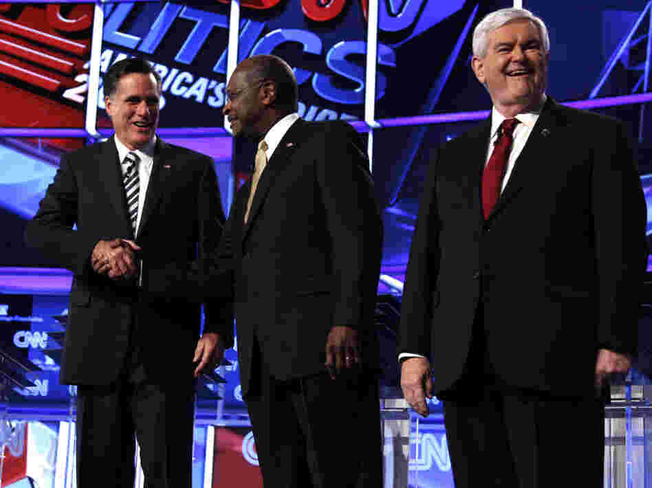 Mitt Romney, Herman Cain and Newt Gingrich before a GOP presidential debate in Washington, Tuesday, Nov. 22, 2011. 