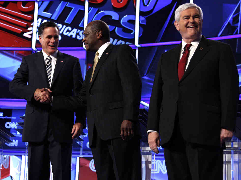 Mitt Romney, Herman Cain and Newt Gingrich before a GOP presidential debate in Washington, Tuesday, Nov. 22, 2011. 