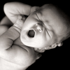 A yawning newborn. A yawning newborn.