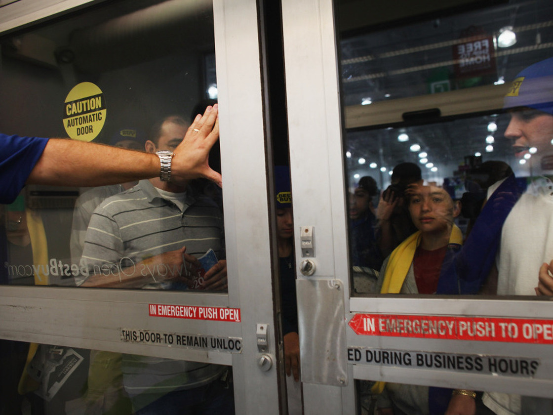 Shoppers wait to get inside of a Best Buy store on Nov. 25 in Naples, Fla.