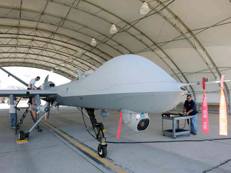 Mechanics prepare an MQ-9 Reaper for a training flight, Aug. 8, 2007, at Creech Air Force Base in Indian Springs, Nev. 