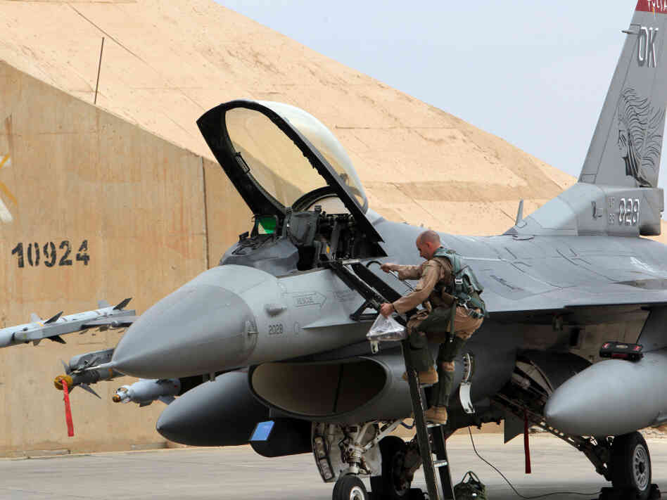 One of the reasons for the shift to unmanned aircraft has been fighter jet budget cuts. Here, a pilot climbs into a U.S. F-16 at Al Asad Air Base in Iraq on Nov. 1. 