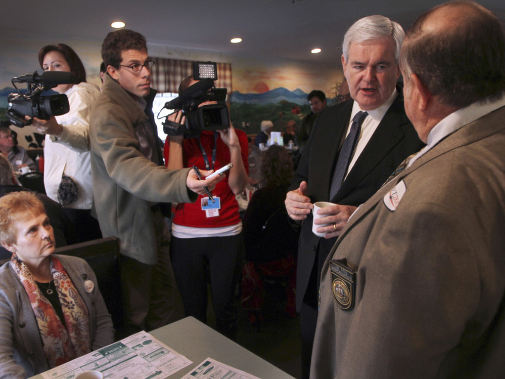 Newt Gingrich talks to New Hampshire State Rep. Joe Pitre during a campaign stop at the Circle Restaurant in Epson, NH.  Friday, Nov. 11, 2011.