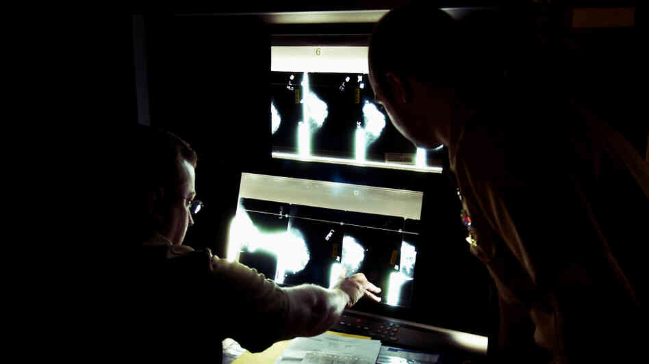 U.S. Navy doctors Lt. Cmdr Ralph Pickard (left) and Ens. Jesse Rohloff study a patient's mammogram images at the National Naval Medical Center in Bethesda, Md. 