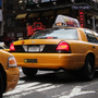 Taxis pass through Times Square in New York City. Taxis pass through Times Square in New York City.