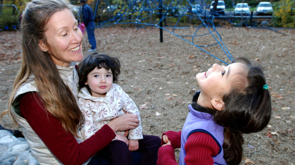 Michele Pereira, who questions the schedule of mandatory vaccines, sat with her daughters, Evangeline, 6, right, and Genevieve, 2, at a park in Ashland, Ore., earlier this month.