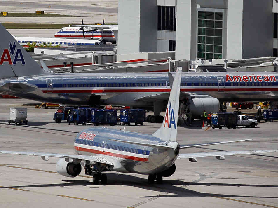 American Airlines planes sit on the tarmac at Miami International Airport. American Airlines planes sit on the tarmac at Miami International Airport.