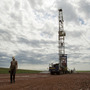Austin Mitchell walks away from an oil derrick outside Williston, N.D. With what many are calling the largest oil boom in recent North American history, temporary camps to house the huge influx of workers now dot the sparse North Dakota landscape.
