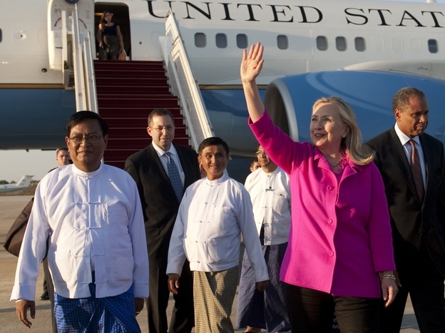 U.S. Secretary of State Hillary Clinton (C) walks on the tarmac upon her arrival in Myanmar on Wednesday. Clinton arrived on the first top-level US visit for half a century. 