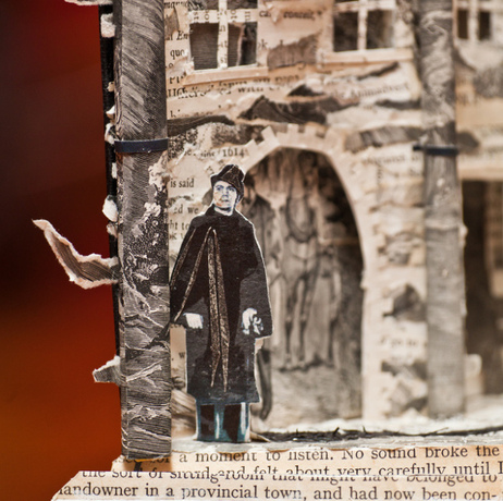 Book sculpture man standing outside