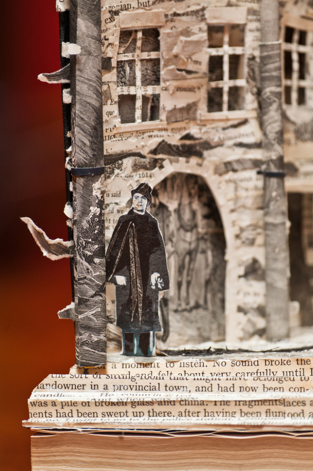 Book sculpture man standing outside