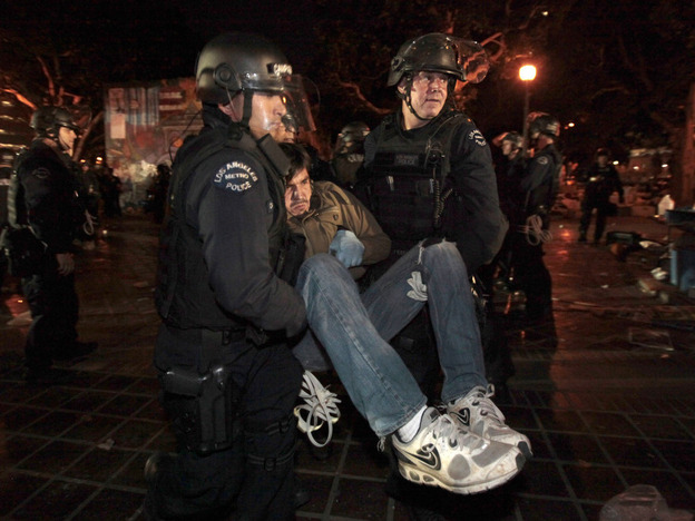 An Occupy protester is arrested early today in Los Angeles as authorities cleared the site near city hall that had been occupied for two months.