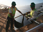 Workers install solar panels at the Soaring Heights Communities at Davis-Monthan Air Force Base outside Tucson, Ariz. Workers install solar panels at the Soaring Heights Communities at Davis-Monthan Air Force Base outside Tucson, Ariz.