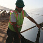 Workers install solar panels at the Soaring Heights Communities at Davis-Monthan Air Force Base outside Tucson, Ariz.