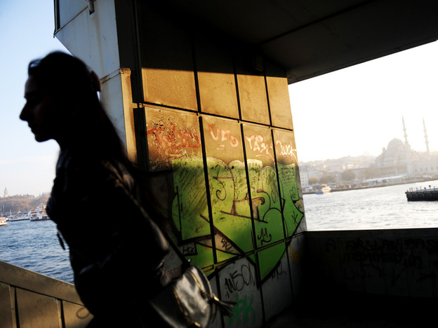A woman walks up the stairs of Galata Bridge in Istanbul. With the financial crisis in the eurozone, Turks are rethinking their years-long bid to be a part of the European Union.