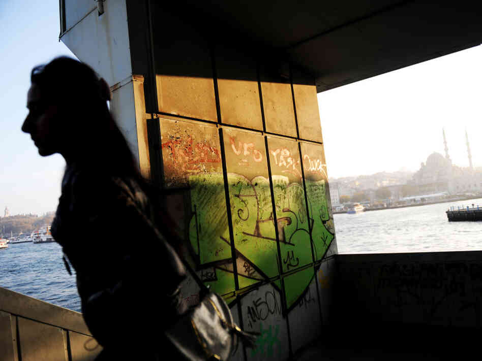 A woman walks up the stairs of Galata Bridge in Istanbul. With the financial crisis in the eurozone, Turks are rethinking their years-long bid to be a part of the European Union.