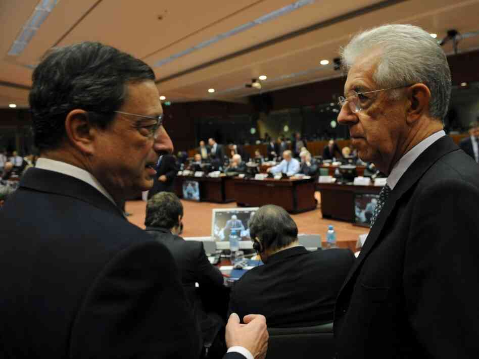 European Central Bank Chief Mario Draghi speaks with Italian Prime Minister Mario Monti at EU headquarters in Brussels on Wednesday. European leaders will meet there next week to discuss their options for fixing the region's sovereign debt crisis.