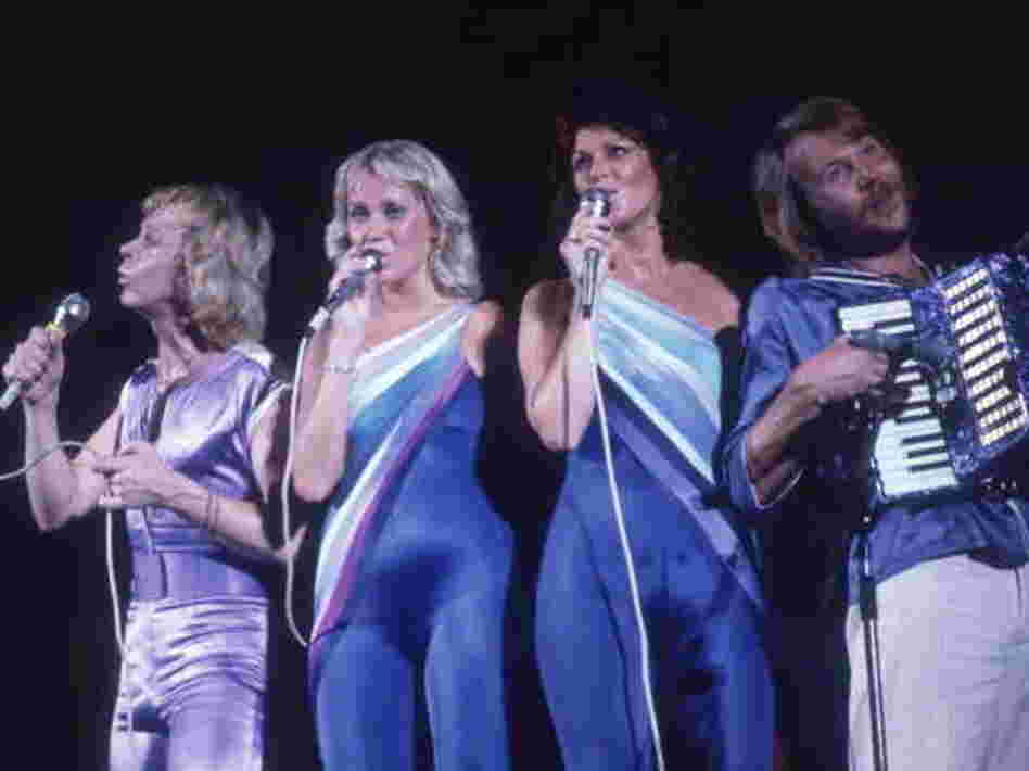 The Swedish musical group ABBA performs onstage in 1979, all wearing blue and lavender spandex outfits.