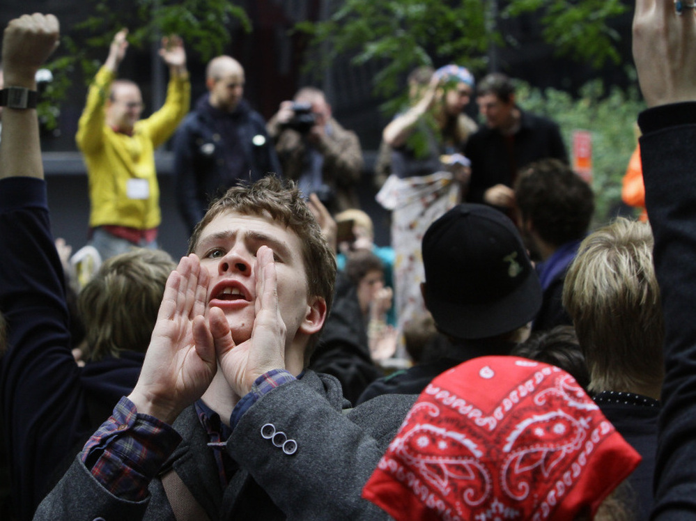 Lucas Brinson, 21, takes on the role of a human microphone, relaying information throughout New York City's Zuccotti Park Occupy Wall Street encampment days before protests were cleared out by police in mid-November.