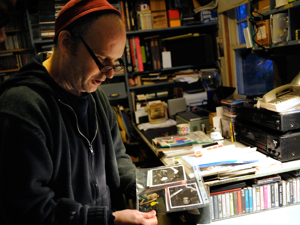 Ian MacKaye examines some fan-submitted live photos in his home office.