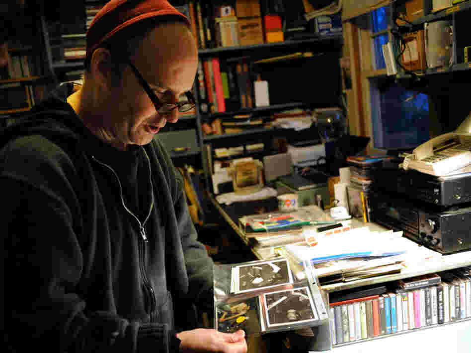 Ian MacKaye examines some fan-submitted live photos in his home office.